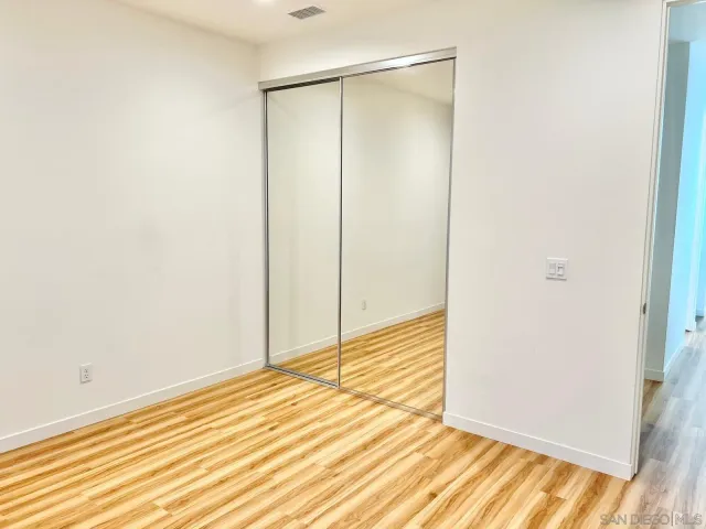a view of a room with wooden floor