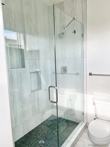 a bathroom with a shower and toilet