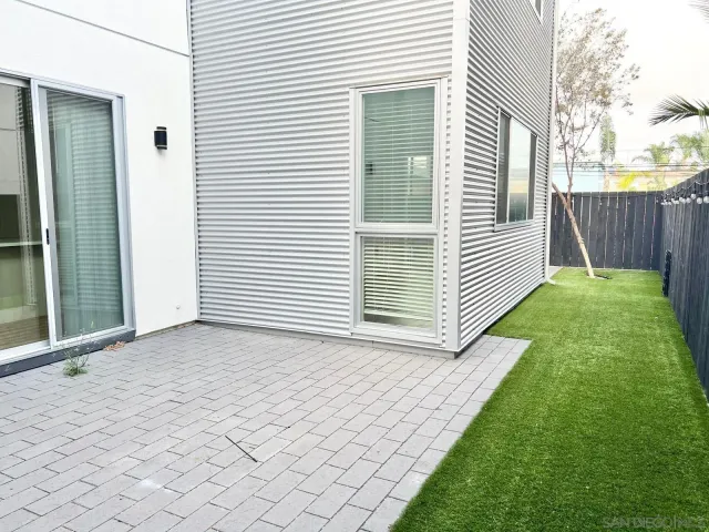 a view of a backyard with wooden fence