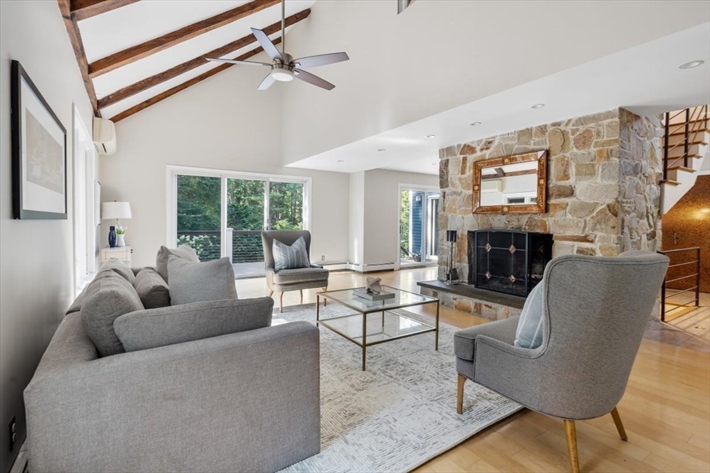 6 Grist Mill Lane Hingham, MA 02043 - Photo 5 of 17 a living room with furniture a fireplace and a large window