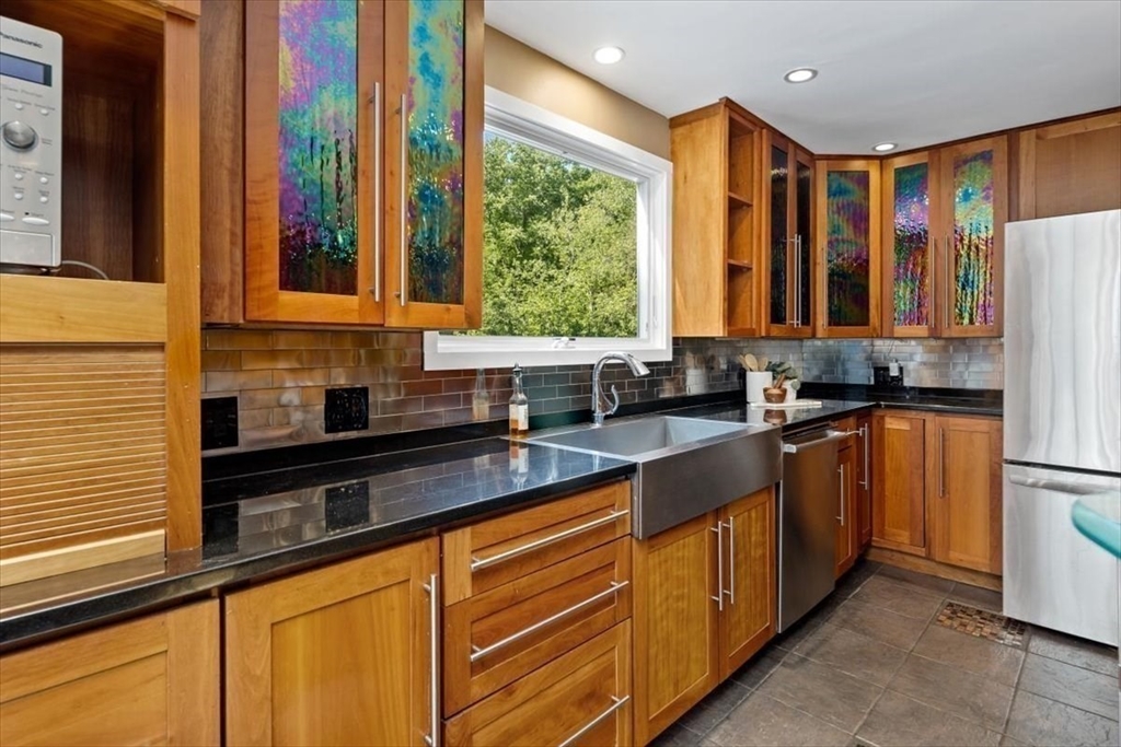 6 Grist Mill Lane Hingham, MA 02043 - Photo 7 of 17 a kitchen with stainless steel appliances a sink window and cabinets