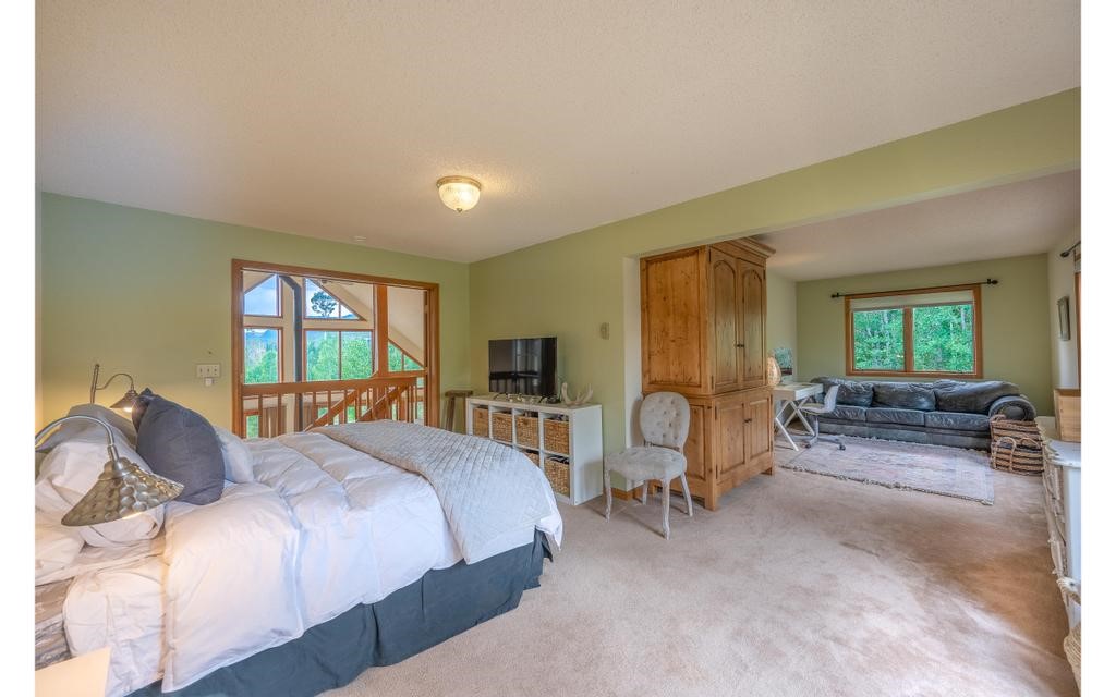 326 Spring Beauty Drive Silverthorne, CO 80498 - Photo 11 of 33 a bedroom with a bed and a couch