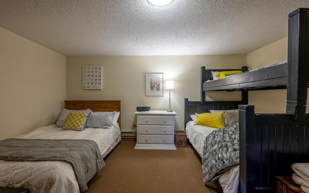 326 Spring Beauty Drive Silverthorne, CO 80498 - Photo 24 of 33 a bedroom with a bed and a couch