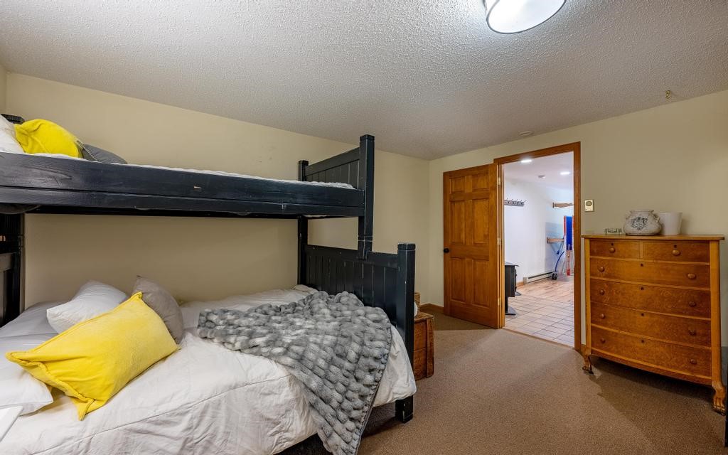 326 Spring Beauty Drive Silverthorne, CO 80498 - Photo 25 of 33 a bedroom with a bed and cabinets