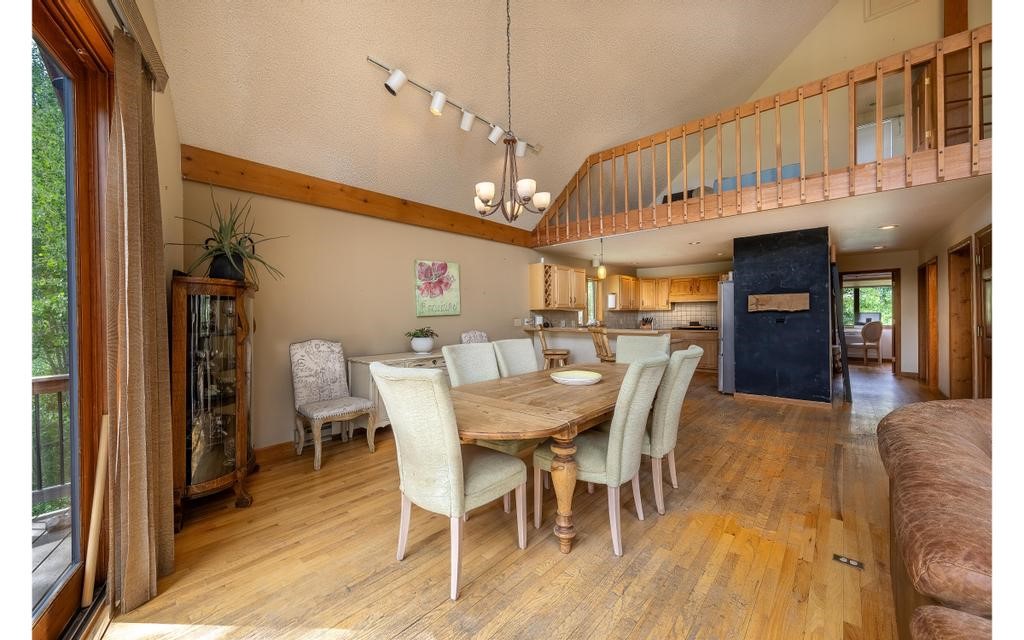 326 Spring Beauty Drive Silverthorne, CO 80498 - Photo 7 of 33 a view of a dining room with furniture window and wooden floor