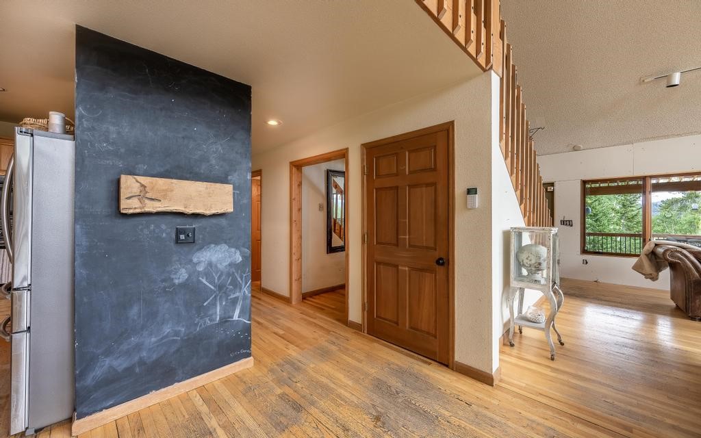 326 Spring Beauty Drive Silverthorne, CO 80498 - Photo 9 of 33 a view of a hallway with wooden floor and windows