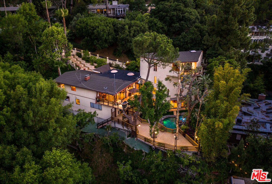 an aerial view of a house with a yard