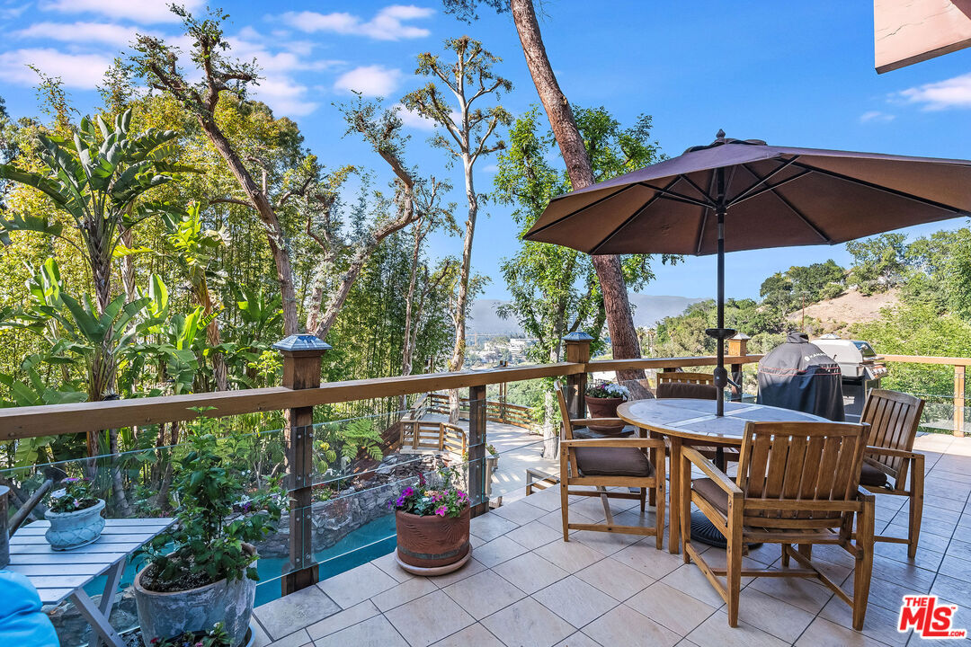 3572 Multiview Drive Los Angeles, CA 90068 - Photo 13 of 51 a view of a chair and tables in the patio
