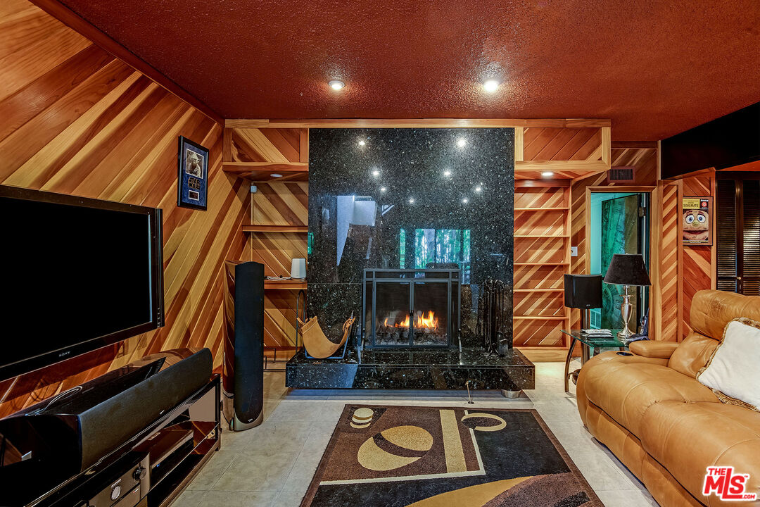 3572 Multiview Drive Los Angeles, CA 90068 - Photo 17 of 51 a living room with furniture a flat screen tv and a fireplace