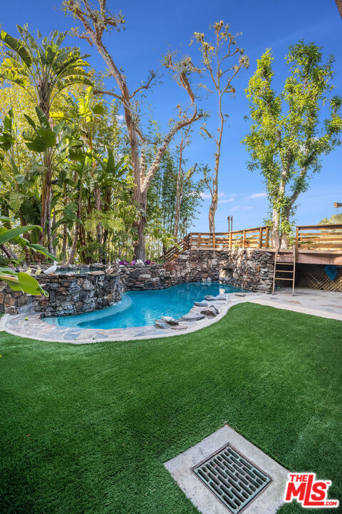 3572 Multiview Drive Los Angeles, CA 90068 - Photo 25 of 51 a view of a wooden bench sitting in the grass