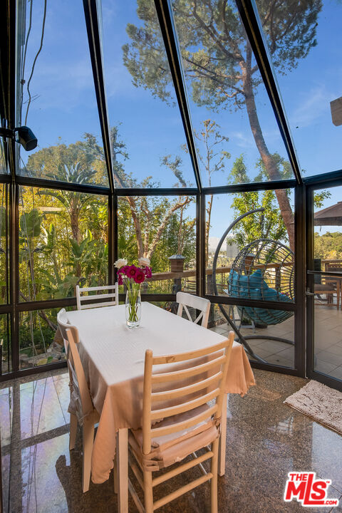 3572 Multiview Drive Los Angeles, CA 90068 - Photo 27 of 51 a view of a dining room with furniture window and wooden floor