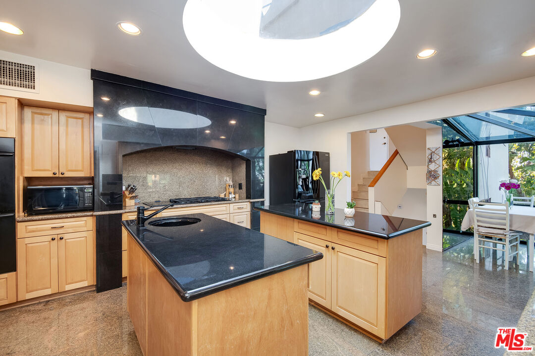 3572 Multiview Drive Los Angeles, CA 90068 - Photo 29 of 51 a kitchen with stainless steel appliances granite countertop a sink a stove and a wooden cabinets