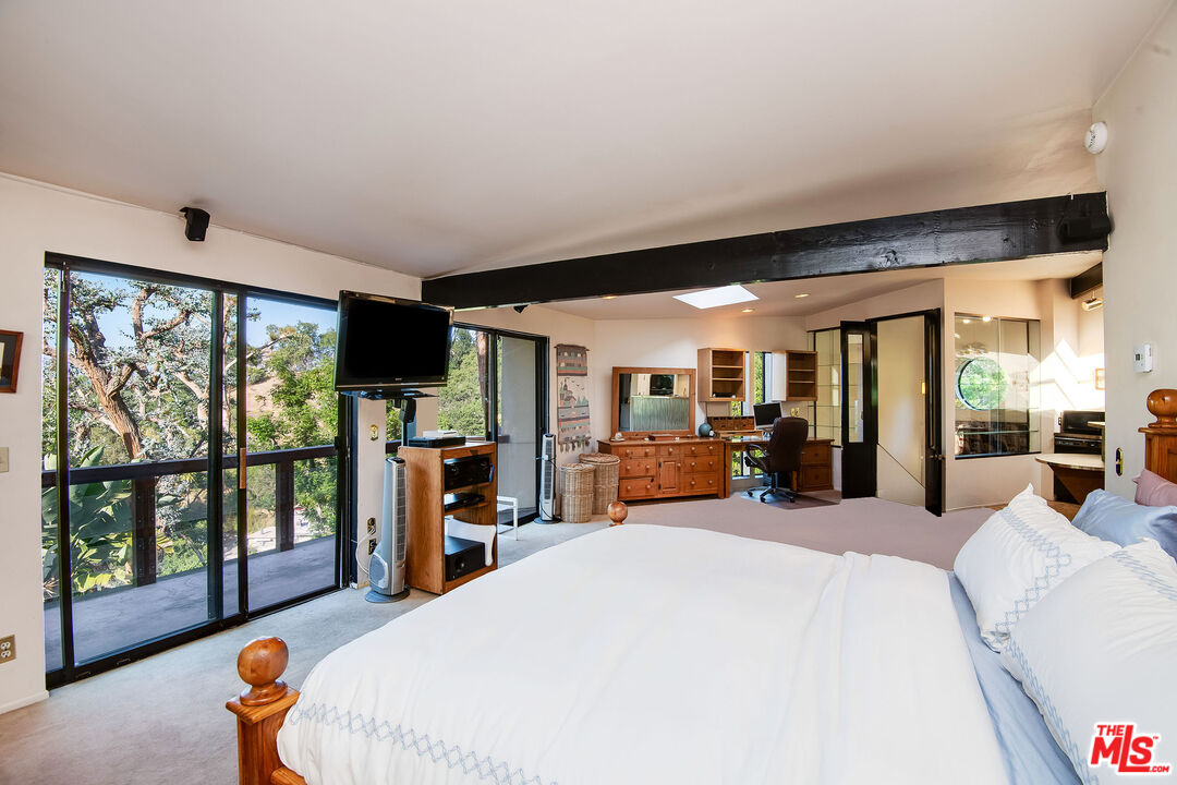 3572 Multiview Drive Los Angeles, CA 90068 - Photo 31 of 51 a large bedroom with a large bed and large windows