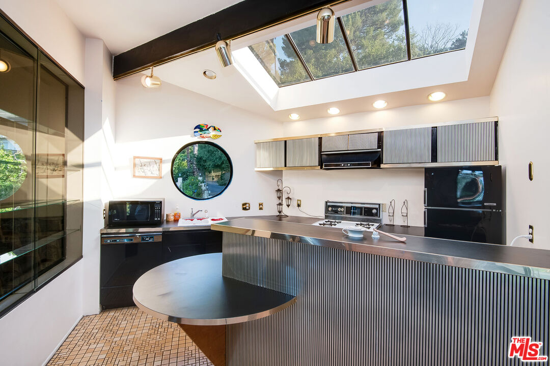 3572 Multiview Drive Los Angeles, CA 90068 - Photo 32 of 51 a kitchen with stainless steel appliances granite countertop a sink a stove and a refrigerator
