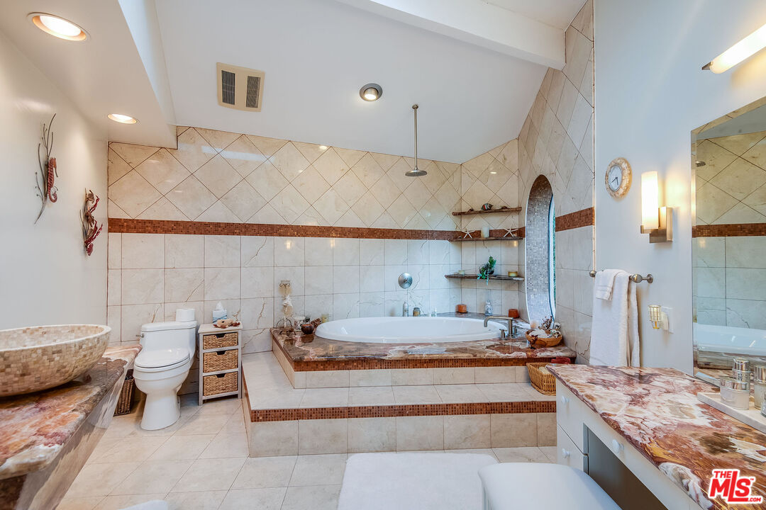 3572 Multiview Drive Los Angeles, CA 90068 - Photo 35 of 51 a spacious bedroom with a bed and a couch