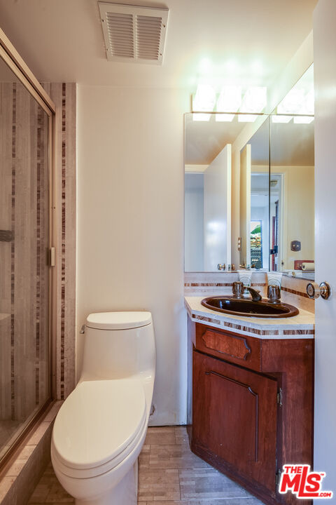3572 Multiview Drive Los Angeles, CA 90068 - Photo 41 of 51 a bathroom with a granite countertop toilet sink and mirror