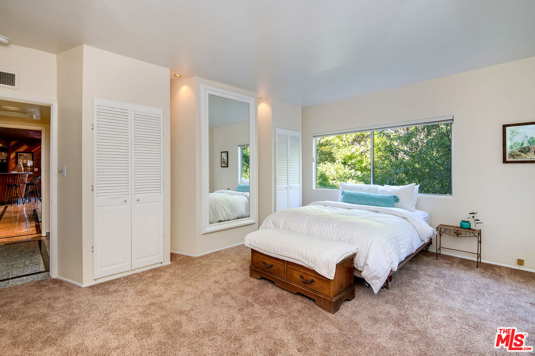 3572 Multiview Drive Los Angeles, CA 90068 - Photo 43 of 51 a spacious bedroom with a bed and a large window