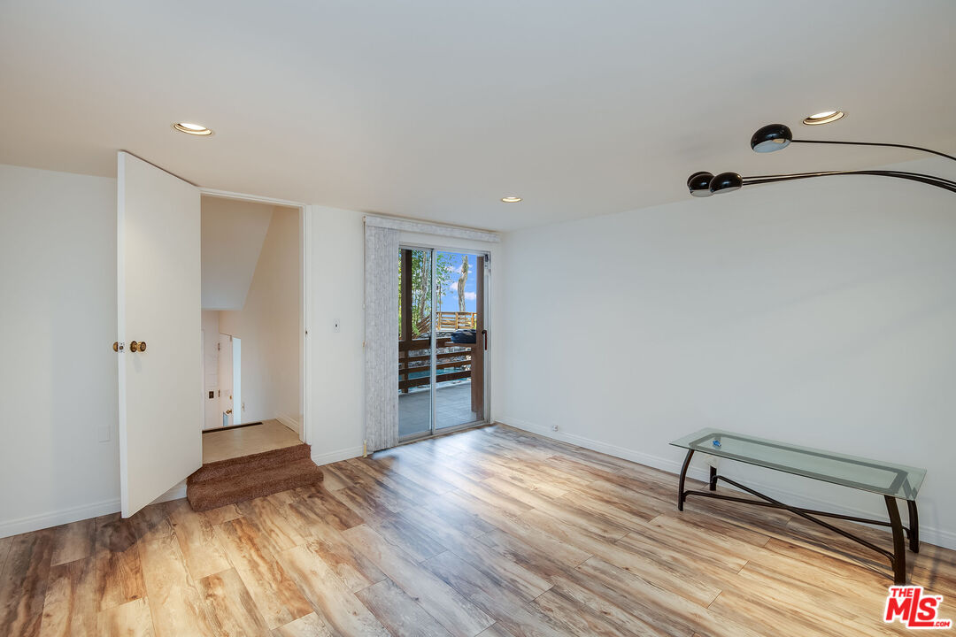 3572 Multiview Drive Los Angeles, CA 90068 - Photo 45 of 51 a view of empty room with wooden floor
