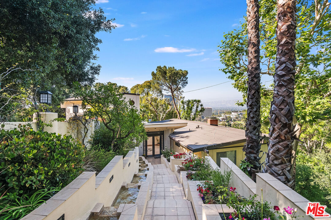 3572 Multiview Drive Los Angeles, CA 90068 - Photo 6 of 51 a view of a patio with table and chairs and potted plants