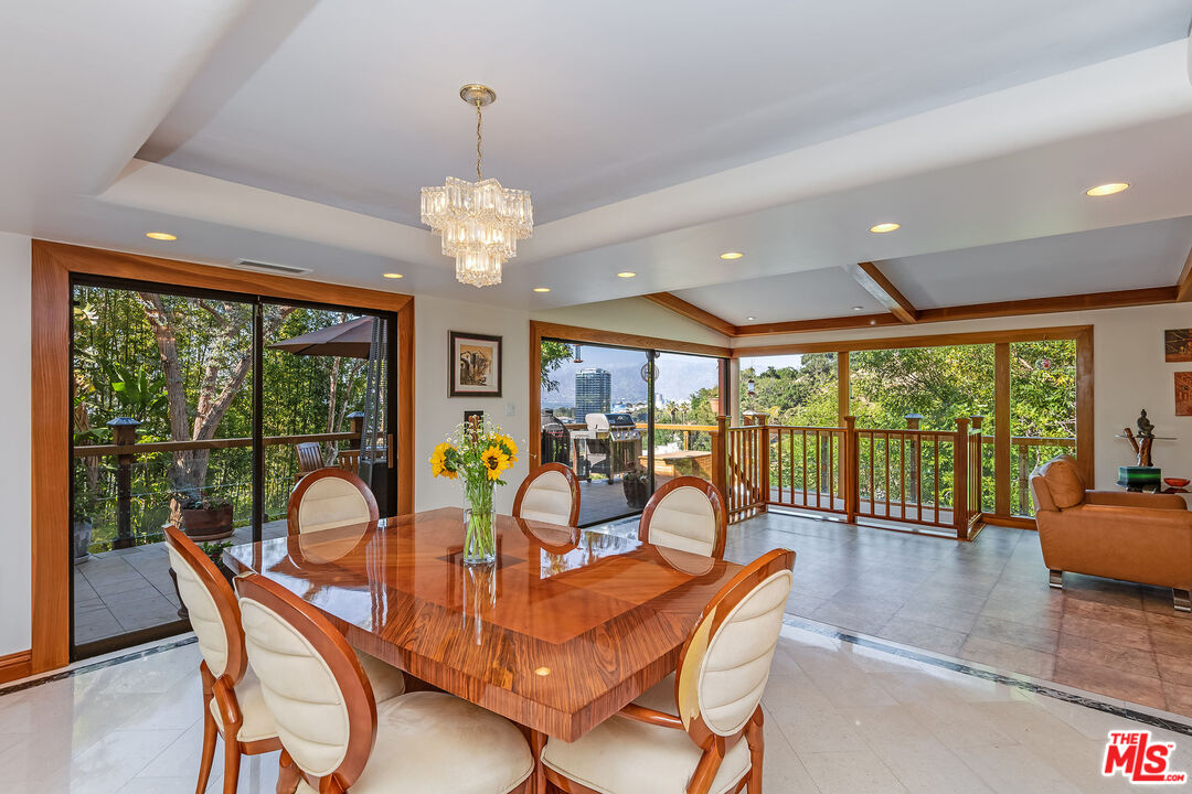 3572 Multiview Drive Los Angeles, CA 90068 - Photo 10 of 51 a view of a dining room with furniture large windows and wooden floor
