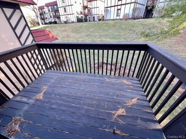 a view of a balcony with wooden floor