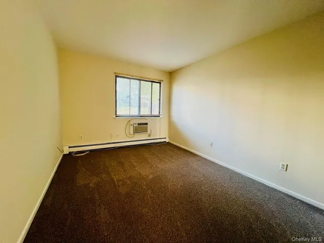 a view of a room with wooden floor and windows