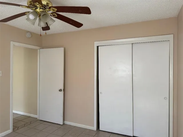 a view of a small space with a chandelier fan