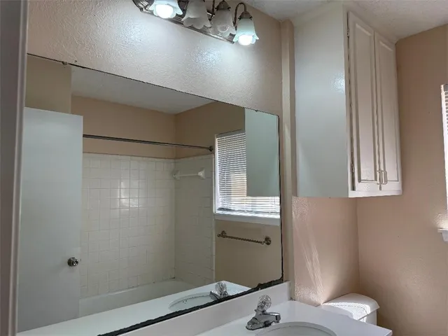 a bathroom with a sink and mirror