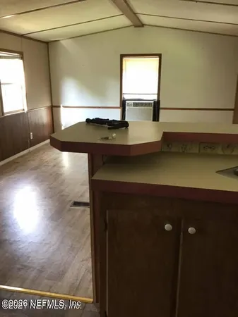 a kitchen with a sink and a refrigerator