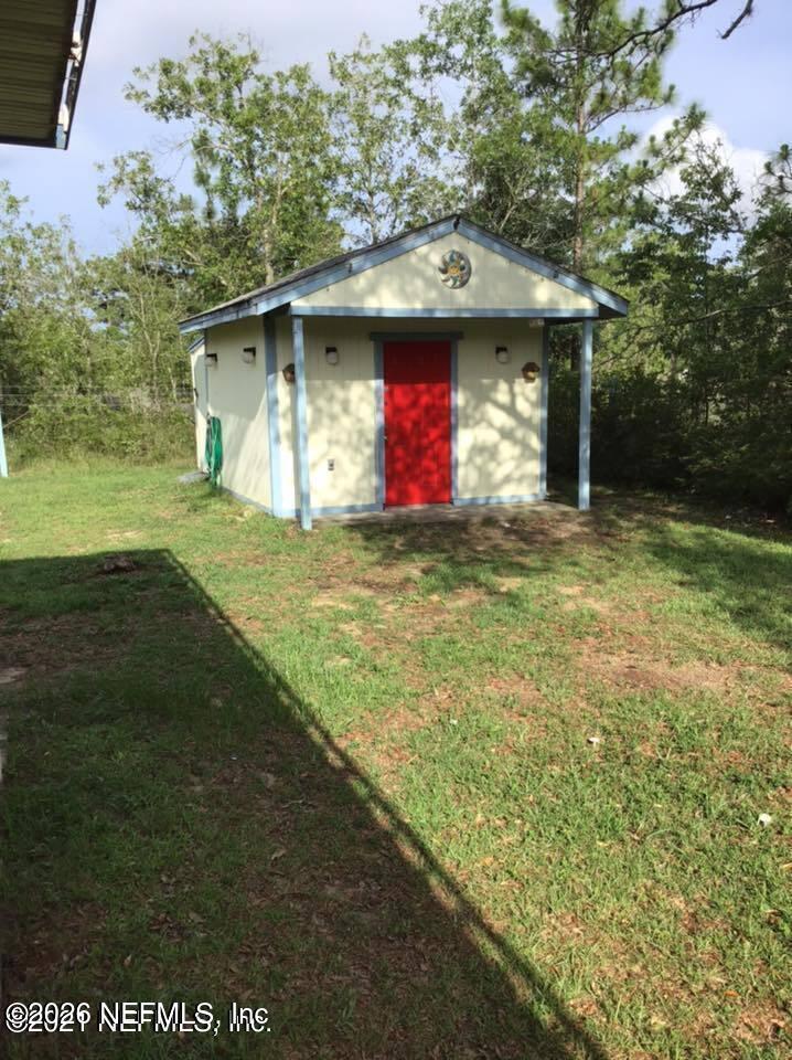 218 Violet Avenue Interlachen, FL 32148 - Photo 6 of 7 a house with a yard