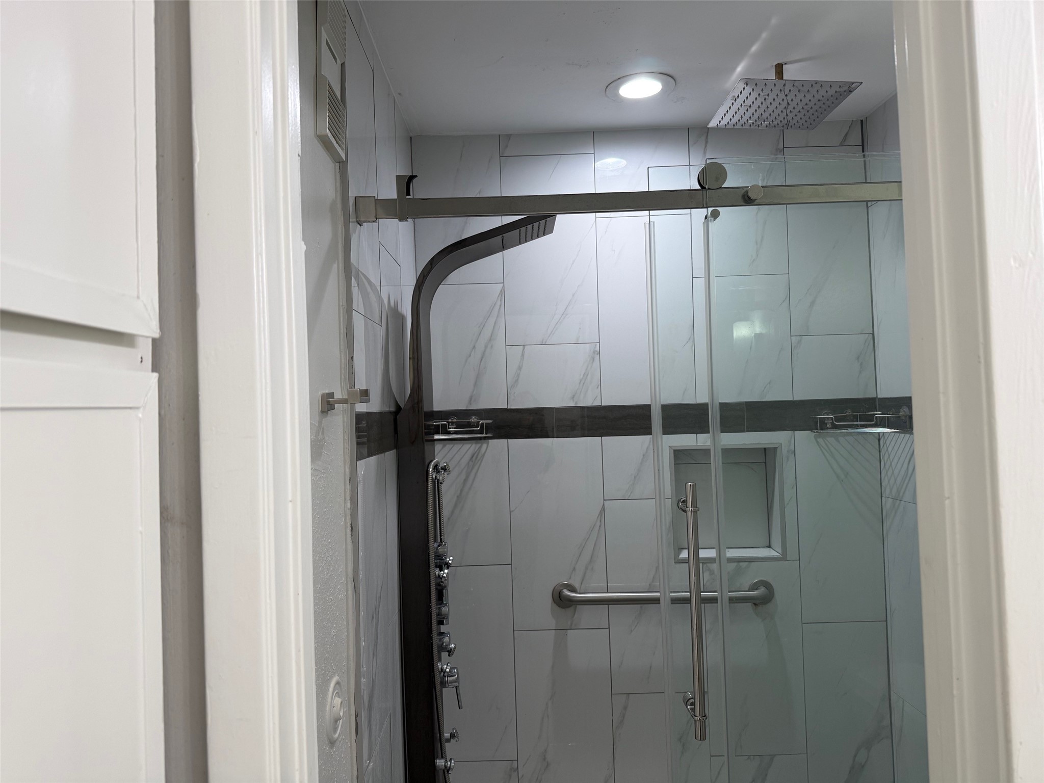 6701 Sands Point Drive, Unit 48 Houston, TX 77074 - Photo 14 of 30 a bathroom with a shower and a glass door