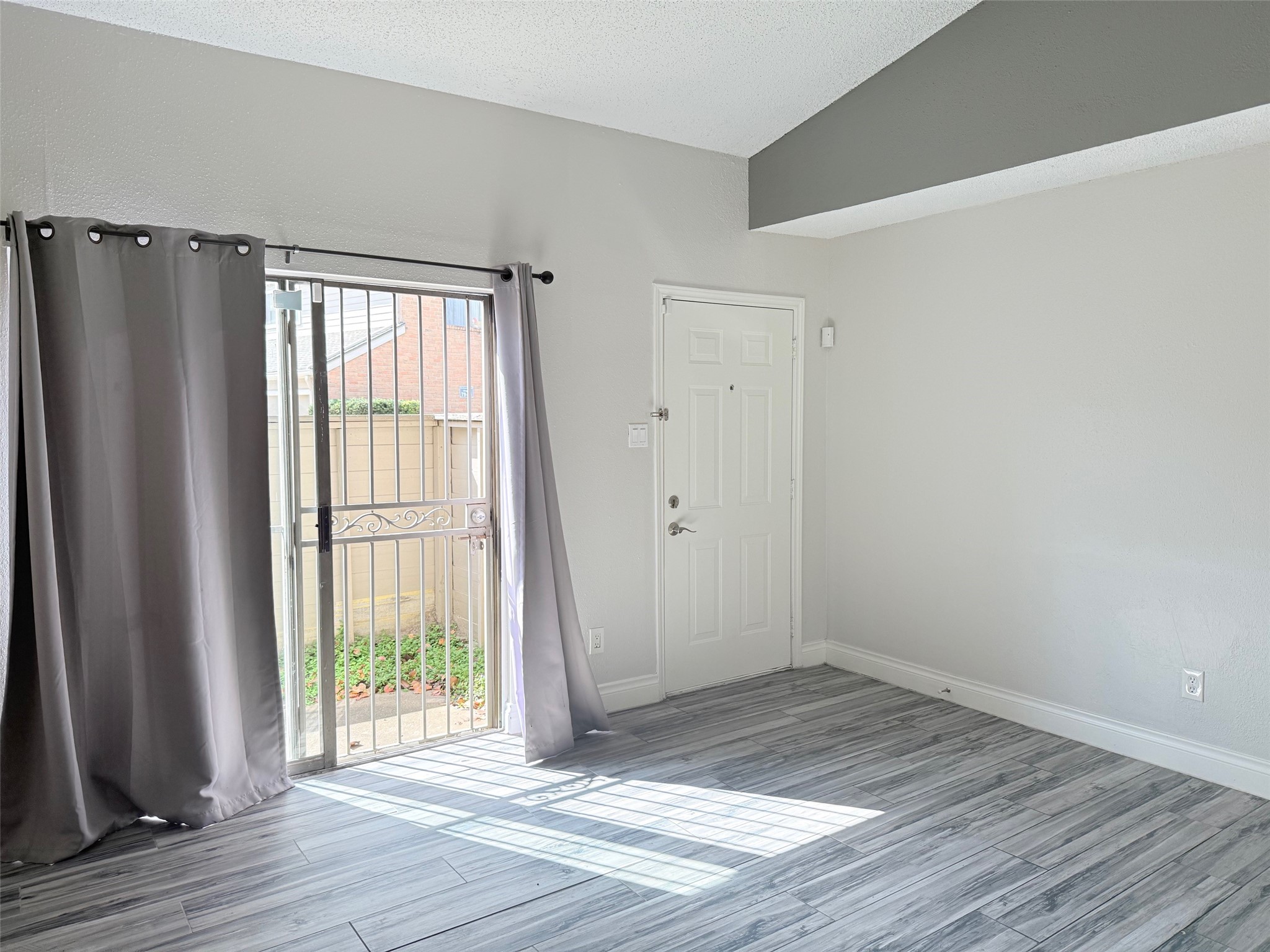 6701 Sands Point Drive, Unit 48 Houston, TX 77074 - Photo 18 of 30 a view of an empty room with wooden floor and a window