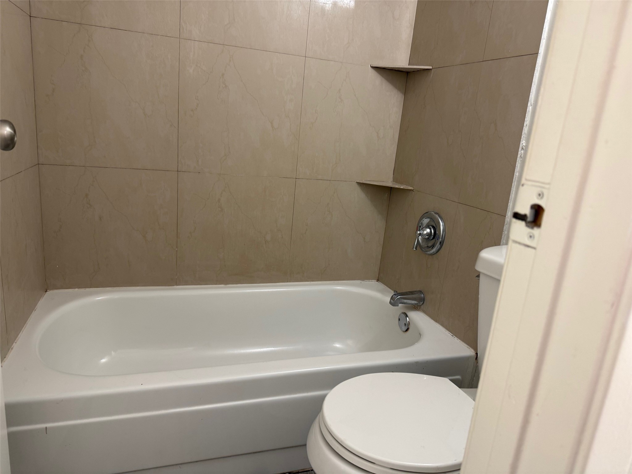 6701 Sands Point Drive, Unit 48 Houston, TX 77074 - Photo 20 of 30 a white bath tub sitting next to a white toilet