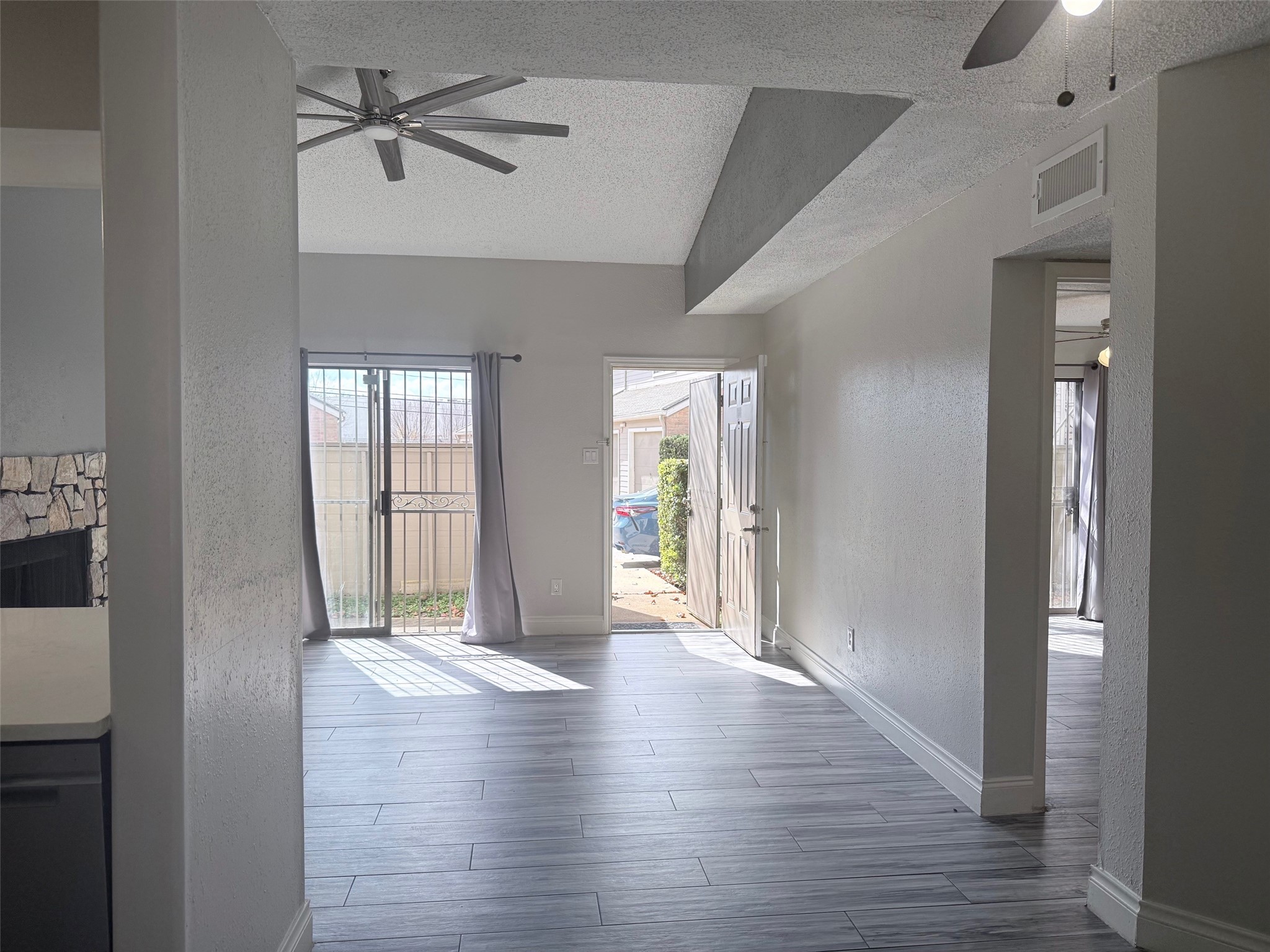 6701 Sands Point Drive, Unit 48 Houston, TX 77074 - Photo 4 of 30 a view of hallway with wooden floor and a ceiling fan