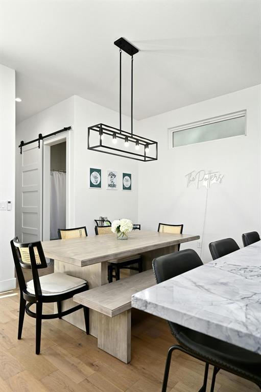 5212 Huisache Street, Unit 2 Austin, TX 78751 - Photo 16 of 30 Dining room featuring a barn door and light wood finished floors