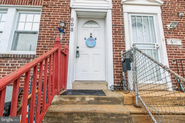 a view of front door of house with stairs