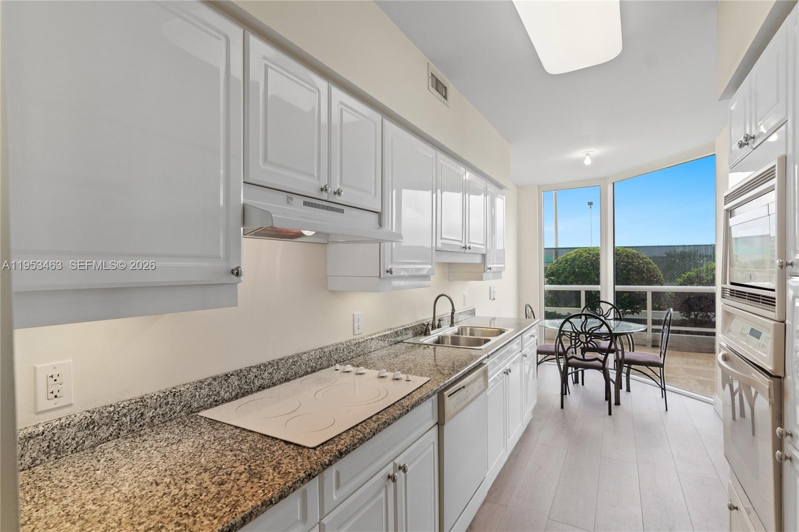 4775 Collins Avenue, Unit 507 Miami Beach, FL 33140 - Photo 14 of 51 a kitchen with a sink a counter top space and appliances