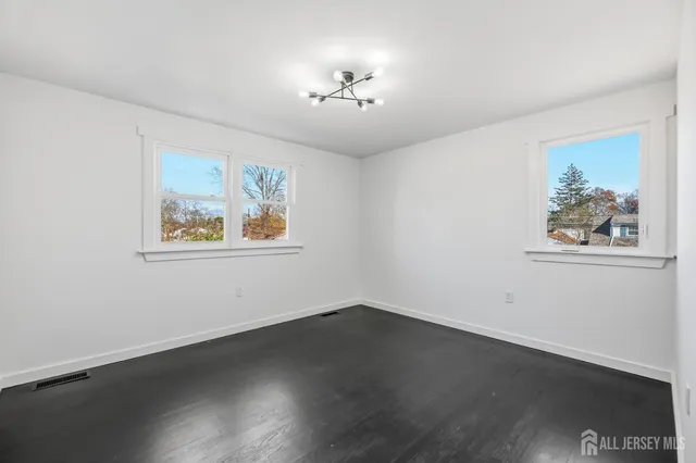 a view of a hallway with wooden floor and a workspace