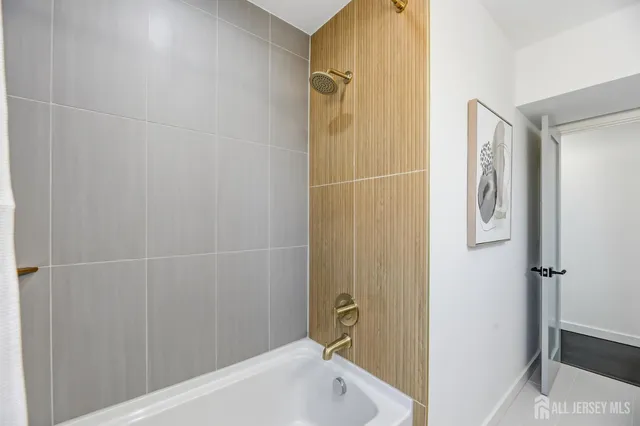 a bathroom with a bathtub and shower