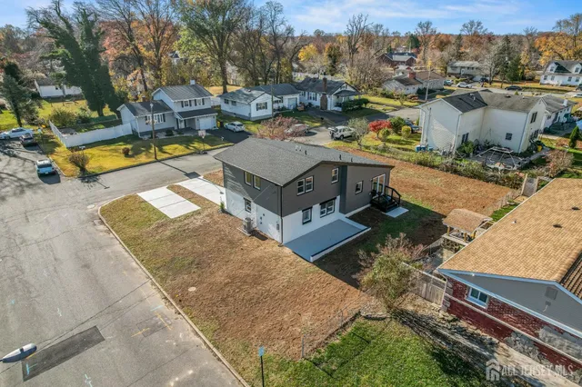 a view of a house with a yard and sitting area