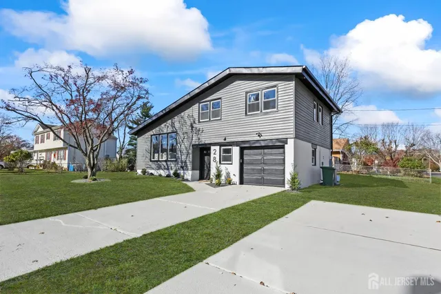 a front view of a house with a yard and garage