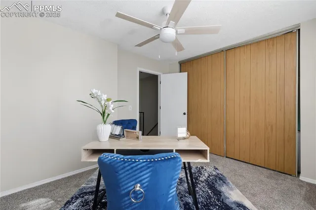 a view of a house with backyard and wooden fence
