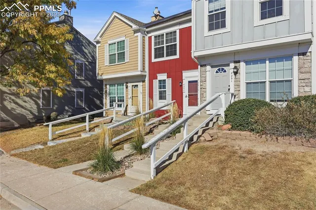 a view of a dining room with furniture and a chandelier