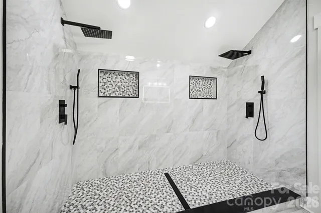 a bathroom with a granite countertop sink a toilet a mirror and a window