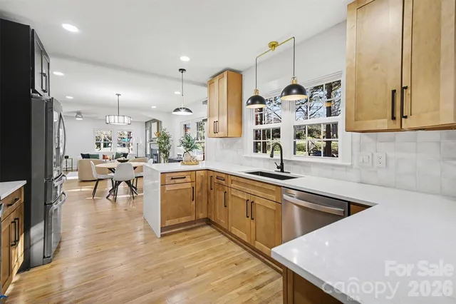 a kitchen with lots of counter top space and painting on the wall