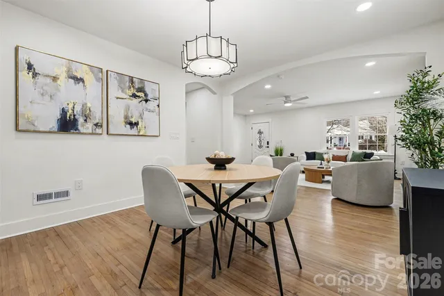 a view of a dining room with furniture wooden floor and a chandelier