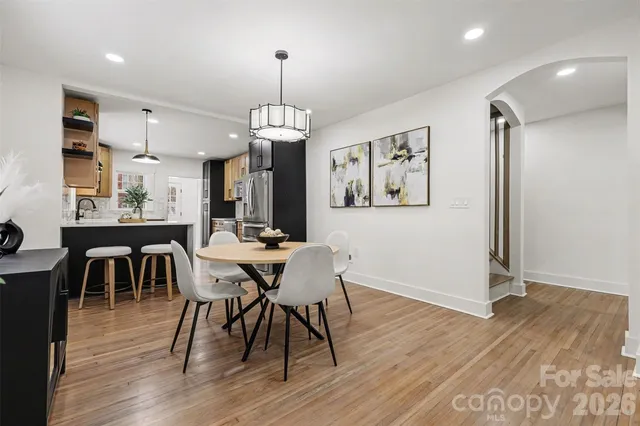a view of a dining room with furniture wooden floor and chandelier
