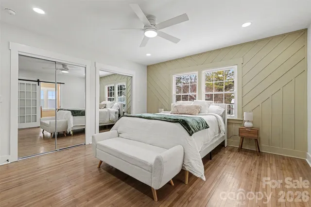 a spacious bedroom with a bed couch and a window