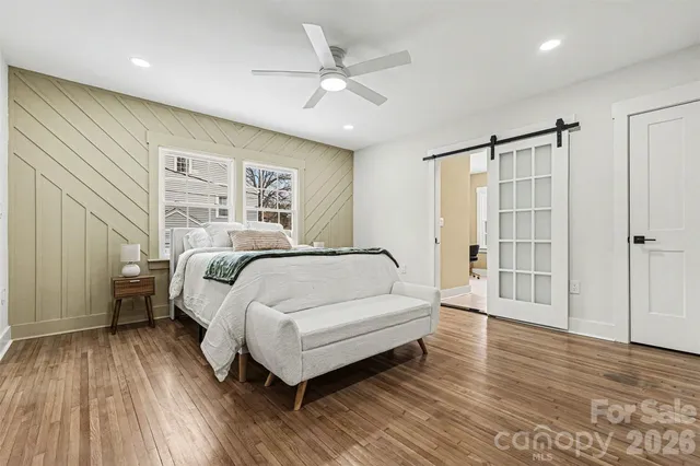 a spacious bedroom with a bed and a table