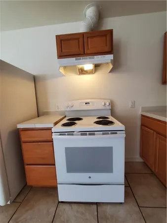 a stove top oven sitting inside of a kitchen